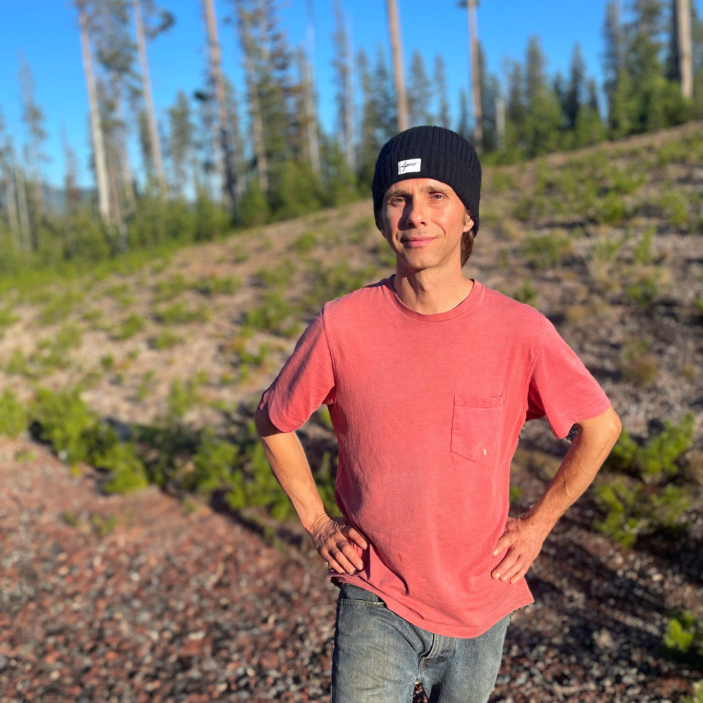 Man wearing black EMF protection beanie, blocking harmful radiation.